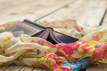 Book and scarf in the wooden backgroundの写真素材