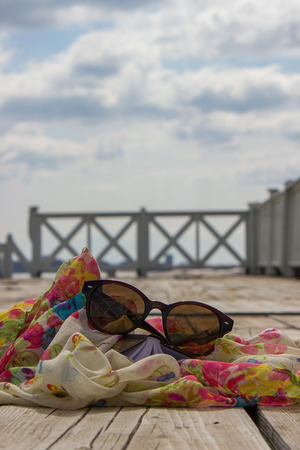 Book and scarf in the wooden backgroundの写真素材
