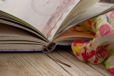 Book and scarf on the wooden backgroundの写真素材