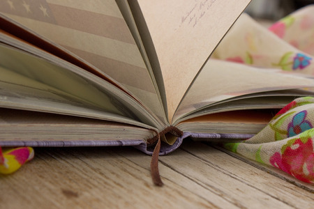Book and scarf on the wooden backgroundの写真素材