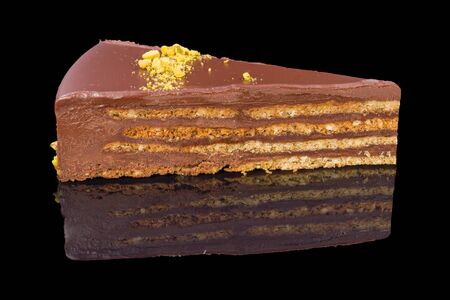 a gourmet piece of chocolate cake, torte with reflection at black backgroundの写真素材