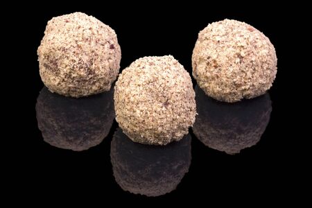 Three balls with walnuts, isolated on black background, with reflectionの写真素材