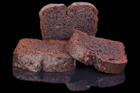 three pieces of dark chocolate cakes, isolated on black background, with reflectionの写真素材