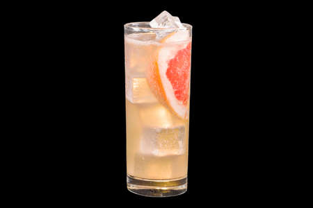 Fresh Paloma Cocktail with ice cubes in a glass, isolated on black backgroundの写真素材