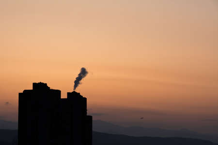 chimneys polluting air, skyscraper, chimney. smoke, silhouetteの写真素材