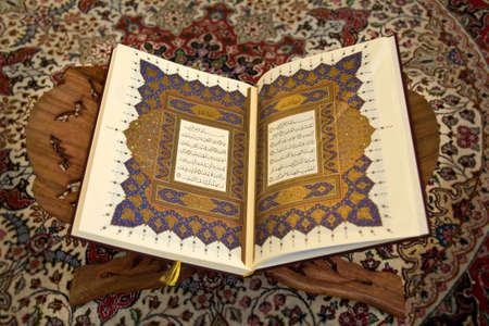 open \\\\\\\\\\\\\\\"Quran\\\\\\\\\\\\\\\" on the shelf with the typical carpet in the backgroundの写真素材