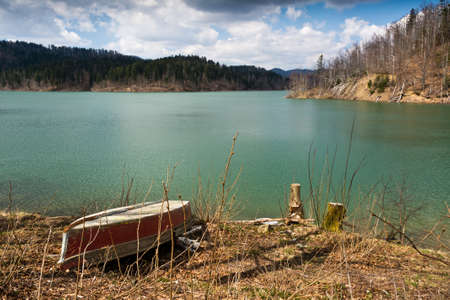 one red boat photographed on the lake shore,Lokve Croatiaの写真素材