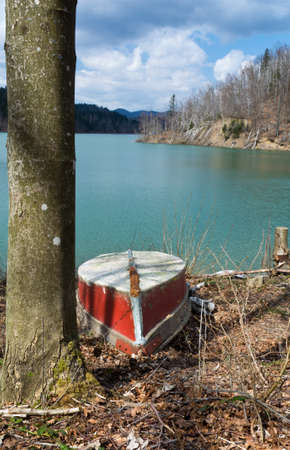one red boat photographed on the lake shore,Lokve Croatiaの写真素材