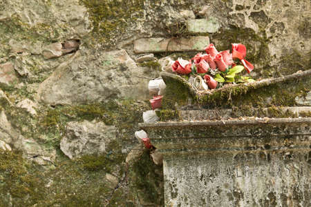Gravestone with red roseの写真素材