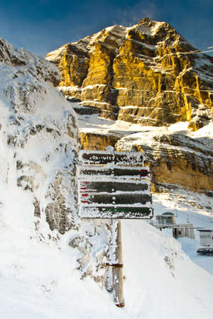 signpost covered in snow , Dolomites , Italyの写真素材