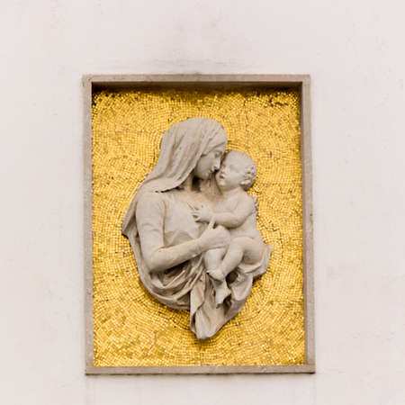 Relief of Virgin Mary  on the facade of the post office in Palmanova, Italyの写真素材