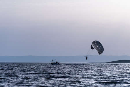 Two people parasailing on the seaの写真素材