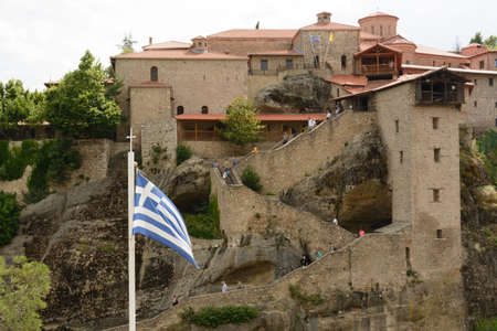 Greek flag in front of the Meteora monasteryのeditorial素材