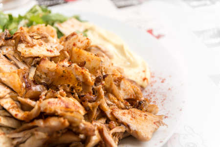 Close up of Gyros or Gyro, Greek dish made of meat cooked on a vertical rotisserie, traditionally pork, or chickenの写真素材