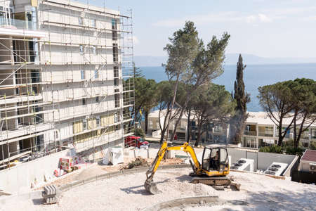 excavator on the site of a new hotel in the city Rabac , Istria region , Croatia. Photographed  March 25.2018.のeditorial素材