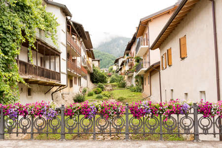 fence decorated with flower vases in the Levico Terme , a village in the Italian Alpsの写真素材