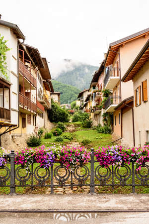 fence decorated with flower vases in the Levico Terme , a village in the Italian Alpsの写真素材
