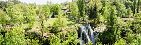 panoramic photo of Village of Rastoke by a Korana river with wooden houses and a waterfall in Croatia.の写真素材