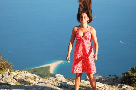 beautiful attractive young girl dancing on vidova gora on brac island, crotiaの写真素材