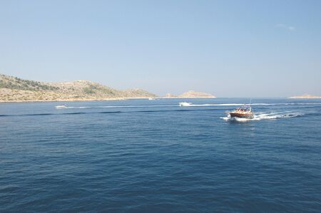 motorboat among majestic picturesque bare rocky islands of Kornati archipelago, Croatiaの写真素材