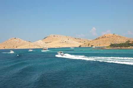 motorboats among majestic picturesque bare rocky islands of Kornati archipelago, Croatiaの写真素材