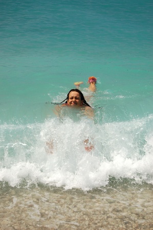 Young girl is playing with waves in Adriatic watersの写真素材