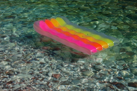 Colored mattress on Adriatic waterの写真素材