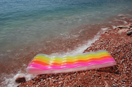 Colored mattress on Adriatic waterの写真素材