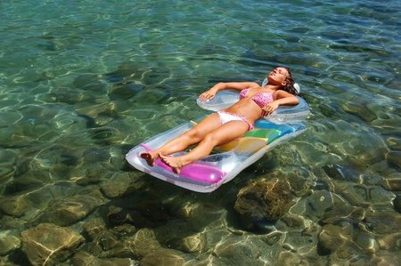 beautiful attractive girl sunbathing on Adriatic waters in Montenegroの写真素材