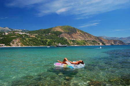 beautiful attractive girl sunbathing on Adriatic waters in Montenegroの写真素材
