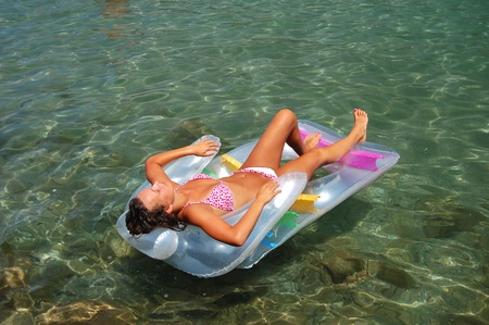 beautiful attractive girl sunbathing on Adriatic waters in Montenegroの写真素材