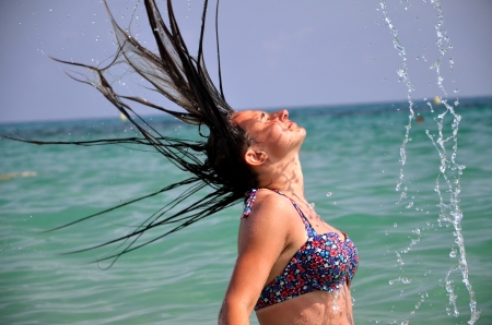 Beautiful attractive young girl having fun in Mediterranean Spanish seaの写真素材