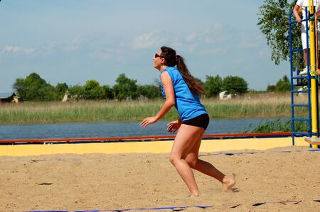 Beautiful teenage girl playing beach volleyballの写真素材