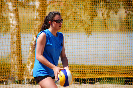 Beautiful teenage girl playing beach volleyballの写真素材