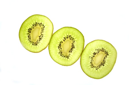 three slices of kiwi isolated on white backgroundの写真素材