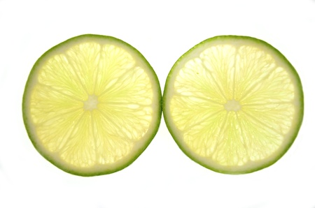 two slices of lime isolated on white backgroundの写真素材