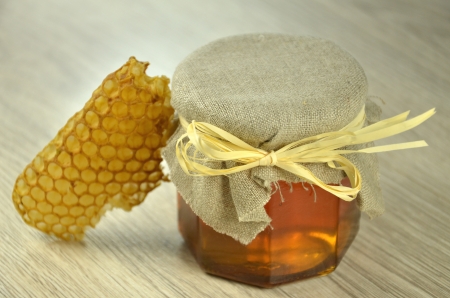 jar of fresh delicious honey with honeycombの写真素材