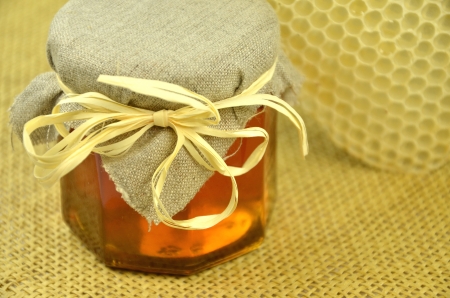 jar of fresh delicious honey with honeycombの写真素材