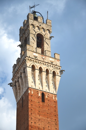 The tower of Palazzo Pubblico on Piazza del Campo in Siena, Tuscany, Italyの写真素材