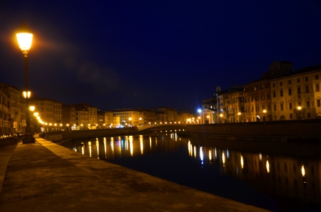 Moody night scene of Arno river in Pisa, Tuscany, Italyの写真素材