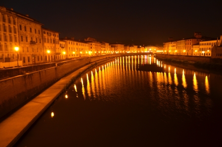 Moody night scene of Arno river in Pisa, Tuscany, Italyの写真素材