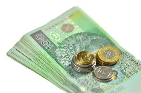 one hundred zloty banknotes and coins from polandの写真素材