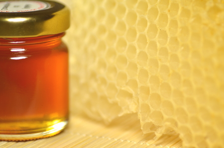  jar full of fresh delicious honey with natural honeycombの写真素材
