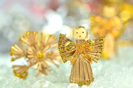 christmas decoration, angel made of straw and bokeh backgroundの写真素材