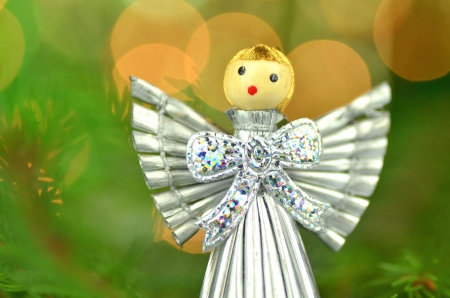 christmas decoration, silver angel made of straw and bokeh backgroundの写真素材