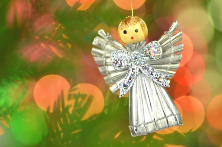 christmas decoration, silver angel made of straw and bokeh backgroundの写真素材