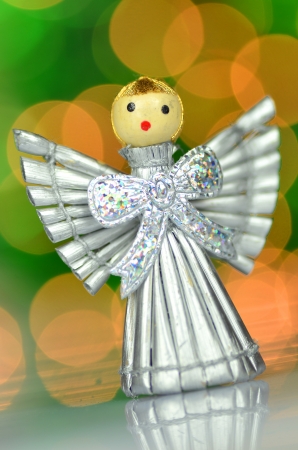 christmas decoration, silver angel made of straw and bokeh backgroundの写真素材