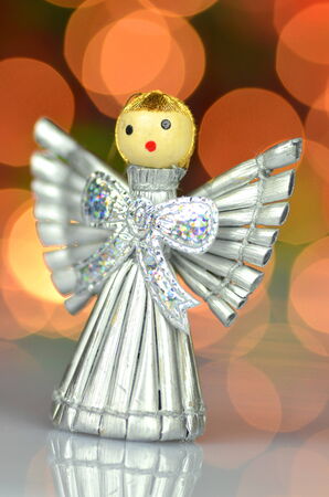 christmas decoration, silver angel made of straw and bokeh backgroundの写真素材