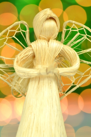 christmas decoration, angel made of straw and bokeh backgroundの写真素材