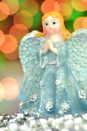 christmas decoration, figure of blue angel against bokeh backgroundの写真素材